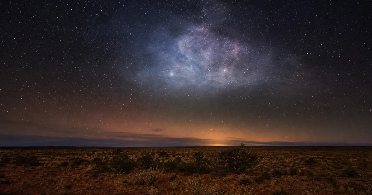Mörk sydhimmel över australiensisk outback med ett stort svagt lysande moln